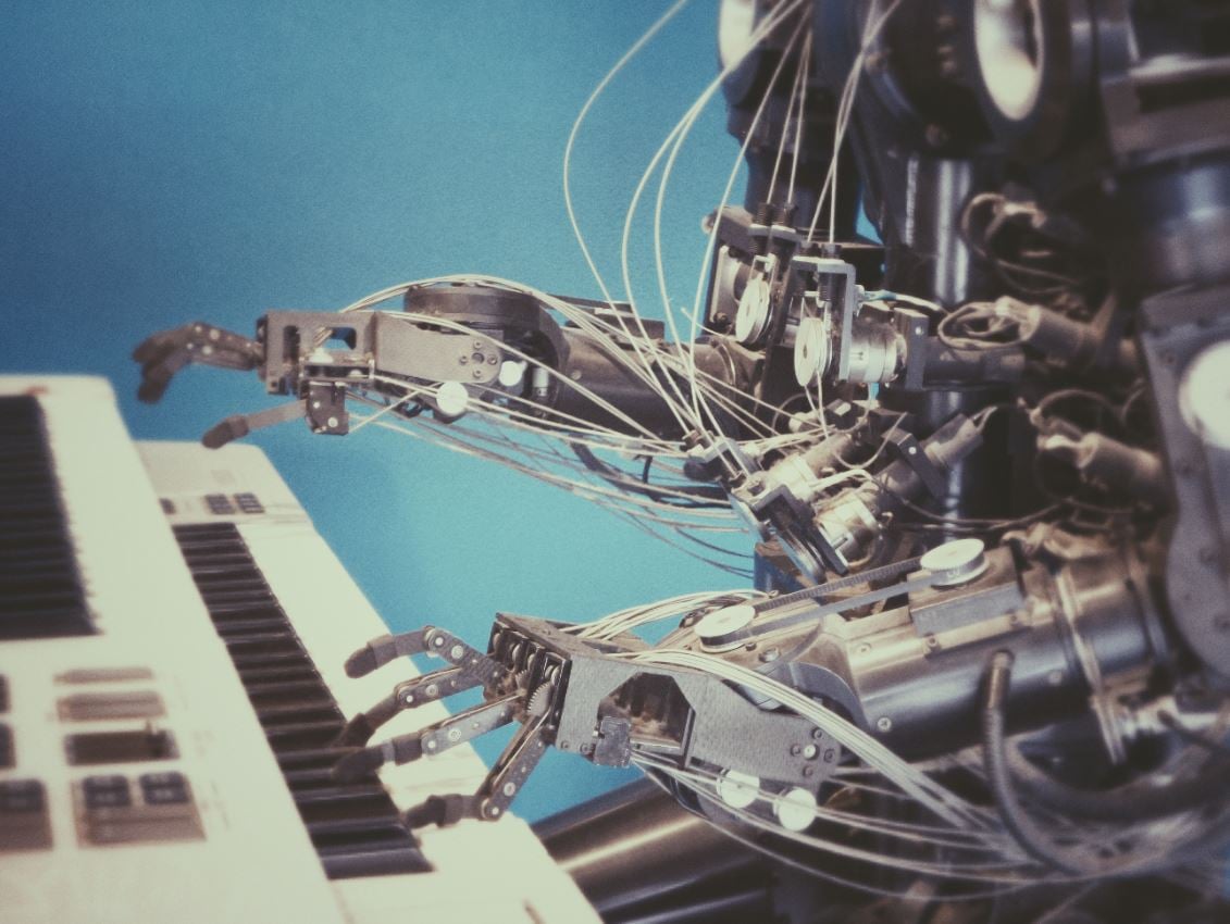 A robot sitting playing piano