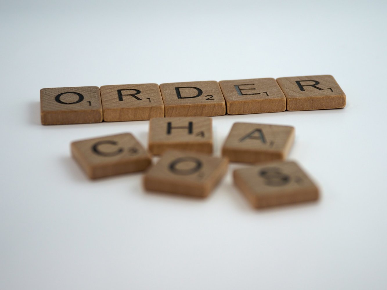Image shows scrabble tiles, five in a line spelling 'order', five scattered spelling 'chaos'