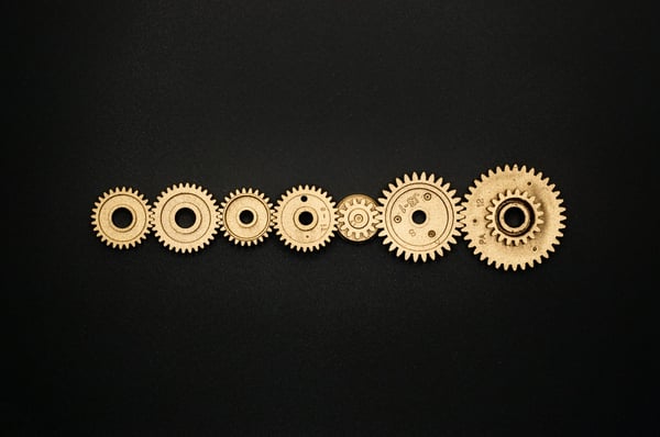 a line of golden gears (image for The benefits and types of automated testing you need to know about blog)